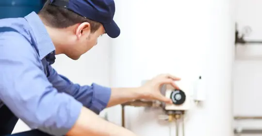 Plumber checking residential water heater